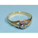 A solitaire diamond ring set a brilliant cut diamond of approximately 0.1ct in an 18ct gold mount,