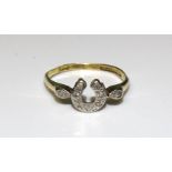 An 18ct gold and platinum ring with diamond-set horseshoe motif, size L, 2.1g.