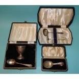 A cased baby spoon and pusher set, Sheffield 1942, a cased silver egg cup and spoon and a cased