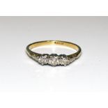 A three-stone diamond ring claw-set three brilliant-cut diamonds, in 18ct gold mount, size P, 2.3g.