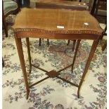 An Edwardian mahogany serpentine rectangular-top occasional table on square splayed legs united by