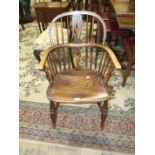 A 19th century yew wood comb-back Windsor armchair on turned legs, (a/f).