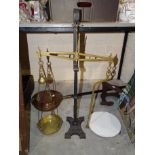 A large brass and iron scale to weigh 7lbs, with brass weight, pan and ceramic tray.