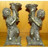 A pair of modern metalled pricket candlesticks, each in the form of a figure supporting a