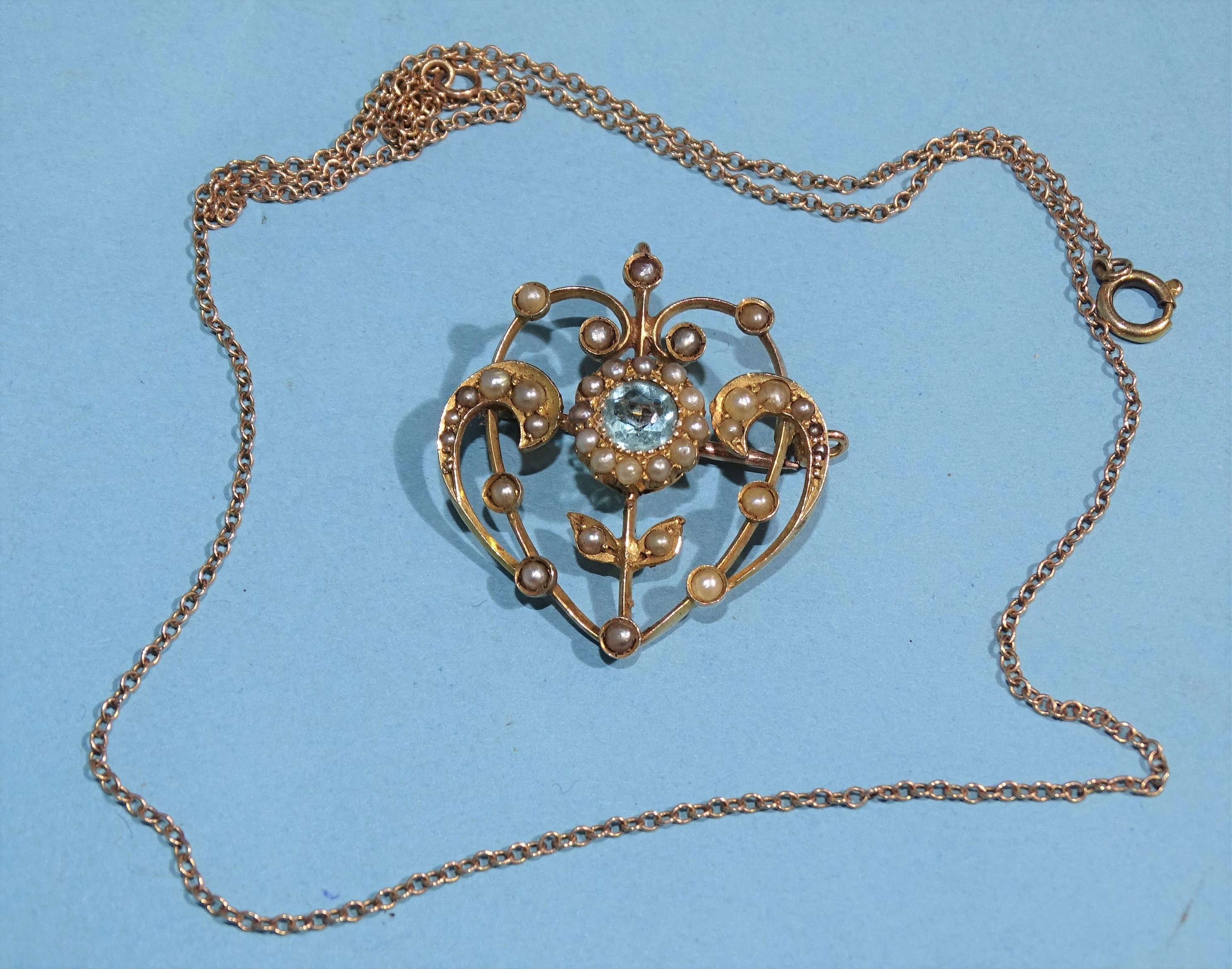 An Edwardian 9ct gold brooch/pendant of scrolling design set blue paste and seed pearls, 3cm x 2.