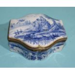 A Continental ceramic trinket box of shaped form, the lid with blue and white decoration of a