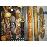 A collection of various modern carved wooden tribal figures, a wooden rainmaker shaker tube and