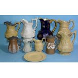 A group of various 19th century drab-ware jugs with moulded decoration, including examples by
