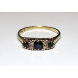 A 9ct gold ring set three sapphires, with pairs of diamonds between, size Q, 2.4g.