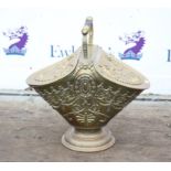 Early 20th century embossed brass coal helmet, with turned handle and twin hinged lids on a