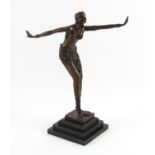 Modern French bronze sculpture of an Art Deco dancer, her arms outstretched, on a stepped base, J.B.