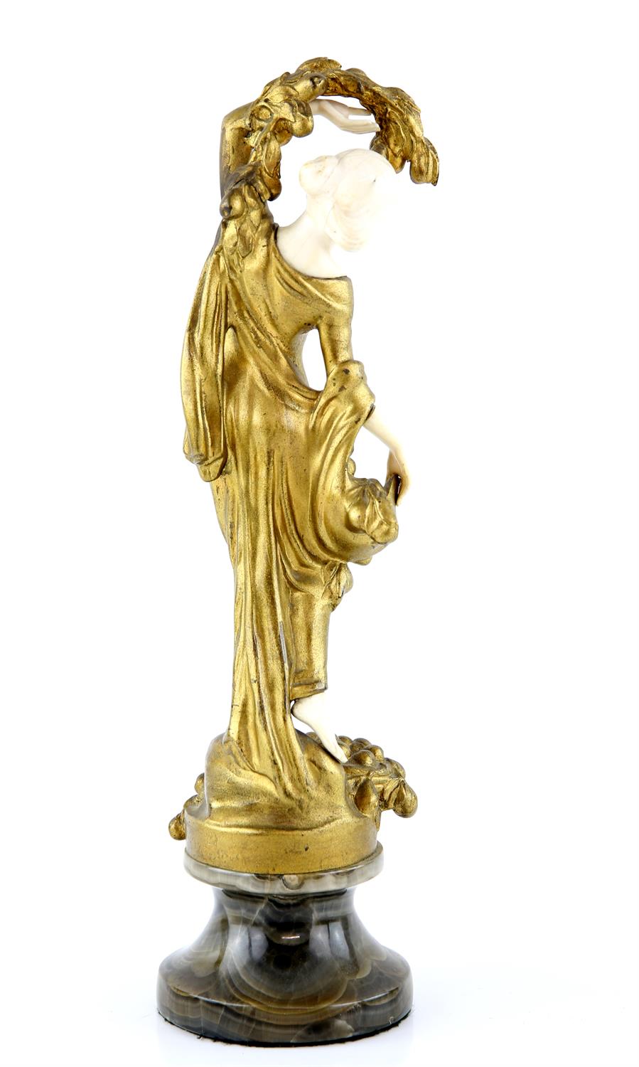 Art Nouveau cast gilt metal and ivoreen figure of a young girl with a basket of fruit at her feet, - Image 3 of 3