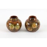 Pair of Linthorpe Pottery vases, of globular form decorated with daisies, stamped mark numbered