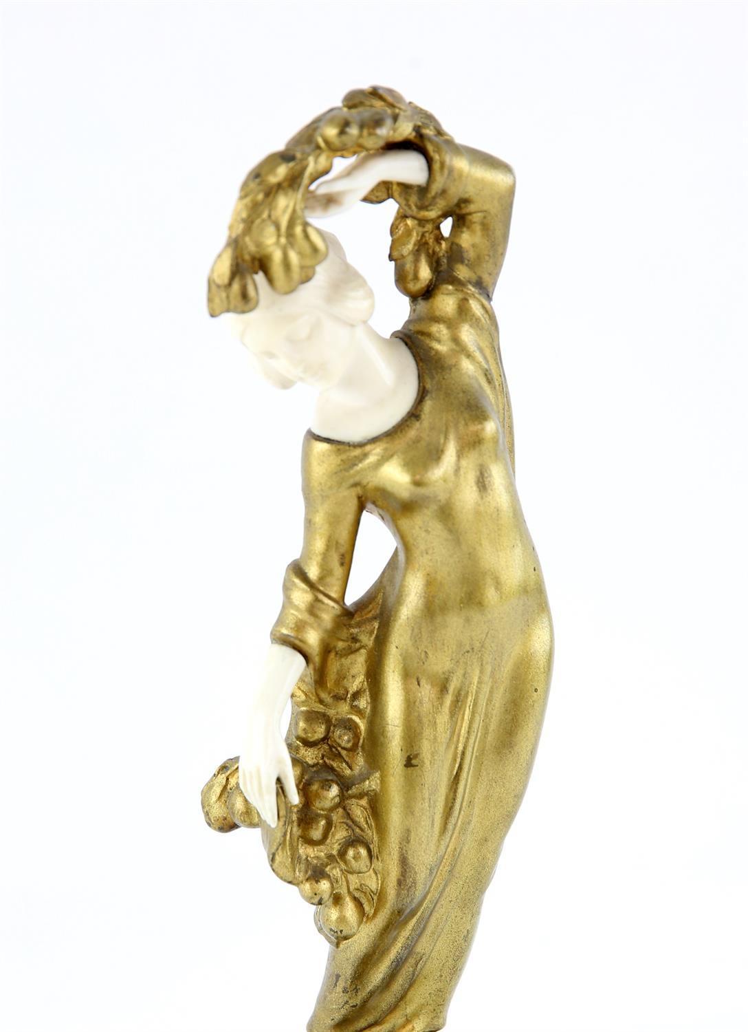 Art Nouveau cast gilt metal and ivoreen figure of a young girl with a basket of fruit at her feet, - Image 2 of 3