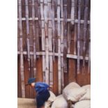 Photograph of a young boy on sand bags, indistinctly signed and numbered 1/25 to lower margin,