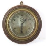 Brass bulkhead clock retailed by Barkers of Kensington, on oak back board, 28cm dia
