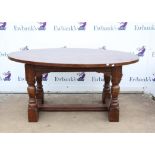 Stained oak table with oval top on turned supports and stretchered base, h76 x w162 x d109cm,