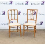 Two satinwood and floral painted bedroom chairs on front sabre legs and stretchers,