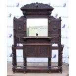 Late 19th/early 20th century carved oak hall stand with scrolling foliage and mask decoration,