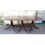George III style mahogany triple pedestal dining table, with rounded ends on ring turned columns