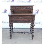 Late 19th/early 20th century carved oak writing desk with drawers over open section over two