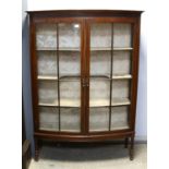 20th century bow fronted mahogany display cabinet on turned and reeded supports, h160 x w115 x