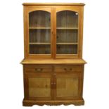 Pine bookcase cabinet, with a pair of glazed doors over two frieze drawers and a pair of panelled