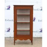 20th century hardwood cabinet with glazed door enclosing shelves on turned supports,