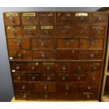 Two walnut apothecary's cabinets, each with 12 short and 8 longer drawers, some with mirrored