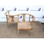 Early 20th century love or conversation chair with caned seats, C-scroll splats and turned legs,