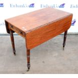 19th century mahogany Pembroke table, with frieze drawer and ring turned tapering legs on castors,