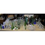 Various green and clear glass bottles, including medicine bottles, dressing bottles,