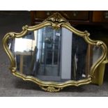 Shaped giltwood wall mirror, 69 x 90 cm and a nest of three tables, with oval tops, H62 W56 D38 (2)