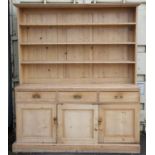 Pine dresser and rack, the top with three shelves over three frieze drawers and three panelled