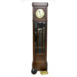 1920s oak longcase clock, the silvered dial with Arabic numerals over a bevelled glazed door and