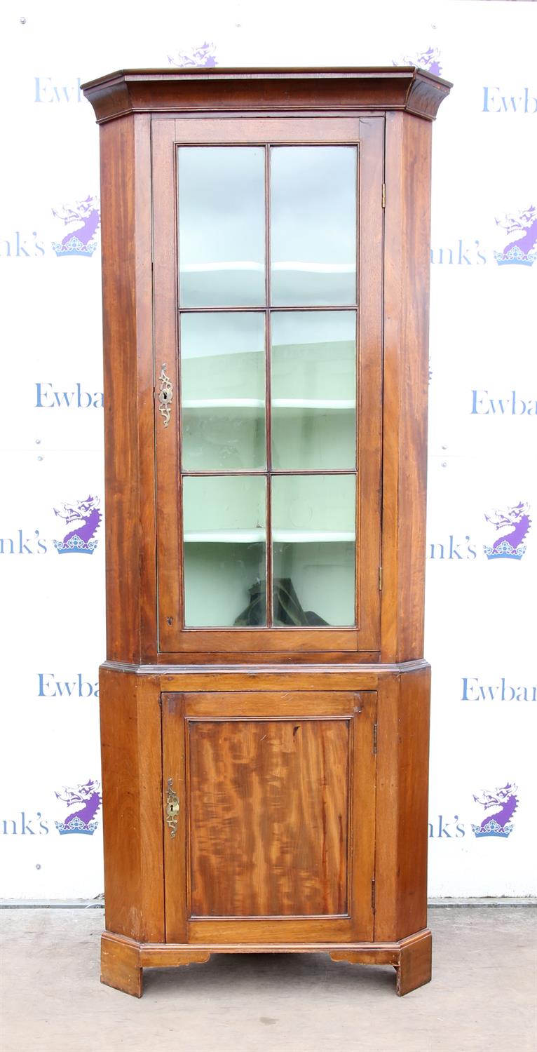 Mahogany standing corner cabinet, the cavetto moulded cornice over a glazed door and panelled door