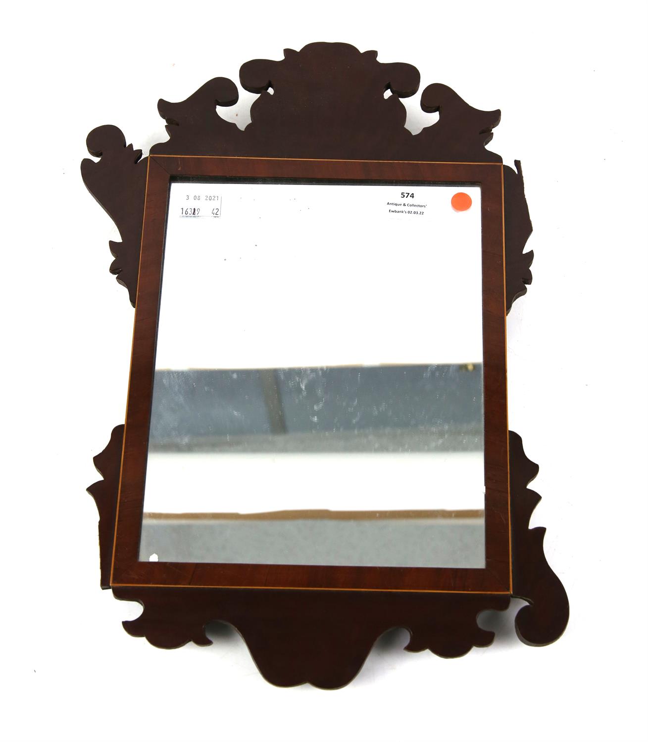 Mirror in shaped Mahogany frame, 42 x 26cm.
