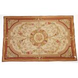 Aubusson style wall hanging, central floral medallion and scrolling floral design on a cream ground,