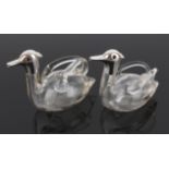 A matched pair of novelty glass oil bottles in the form of ducks, the silver heads with glass eyes,