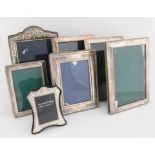 Seven silver photograph frames, the largest 24cm x 17cm Sold on behalf of Woking And Sam Beare