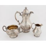 Victorian silver three piece part tea service, comprising hot-water jug, cream jug and sugar bowl,