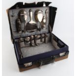 Early 20th century blue leather dressing case and cover with silver topped jars, mirrors,