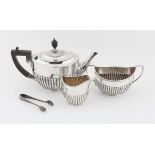 Three piece silver tea service, of reeded boat form, Sheffield 1915, William Hutton & Sons,