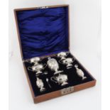 Edward VII eight piece silver cruet set by Henry Matthews, embossed with rams heads and swags,