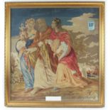 19th century wool tapestry depicting three figures with an urn, buildings beyond. Framed and glazed.