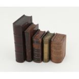 Five 19th century snuff boxes in the form of miniature books, comprising three carved wood,