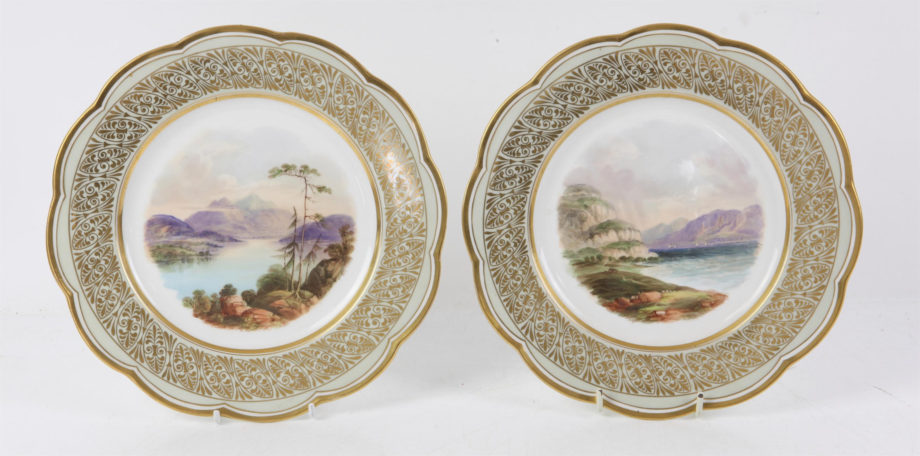 Pair of Davenport plates, with green and anthemion design gilt borders, painted with a scene of