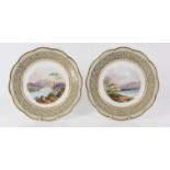 Pair of Davenport plates, with green and anthemion design gilt borders, painted with a scene of
