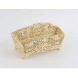 Far Eastern ivory desk tidy, the two compartments with pierced decoration depicting winged figures,