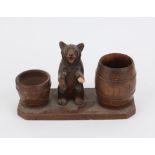 Late 19th/early20th century Black Forest group of a bear on his hind legs with two barrels,